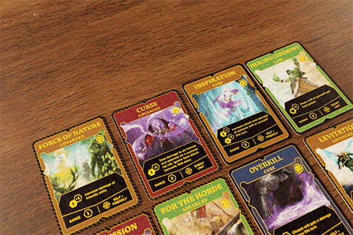Close-up of spell and ability cards fanned on the table